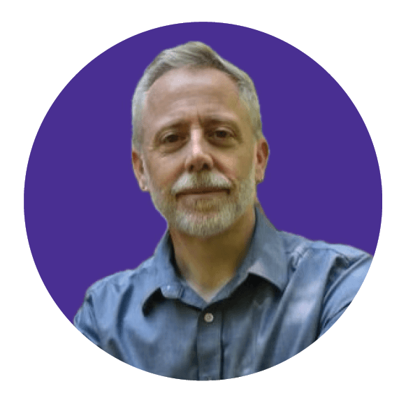 Smiling woman giving a piggyback ride to a laughing young girl.